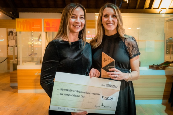 Image shows two women holding a cheque