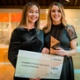 Image shows two women holding a cheque
