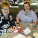 Image shows two people at a cafe table.