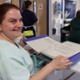 A member of hospital catering looking through a folder displaying information about swallowing difficulties
