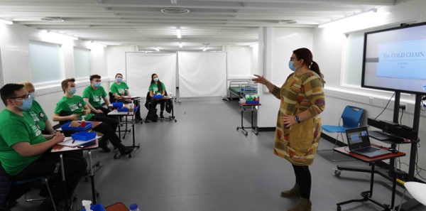 Lorna Pearce, pharmacist, addresses the class of volunteers.