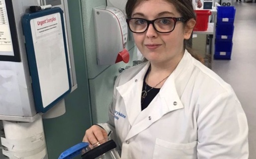 Project SEARCH intern Chloe Davies unpacks a pod to be cleaned in the pathology lab.