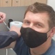 Image shows a patient receiving his flu vaccination