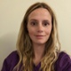 Image of Lisa Keane smiling at camera in purple scrubs.