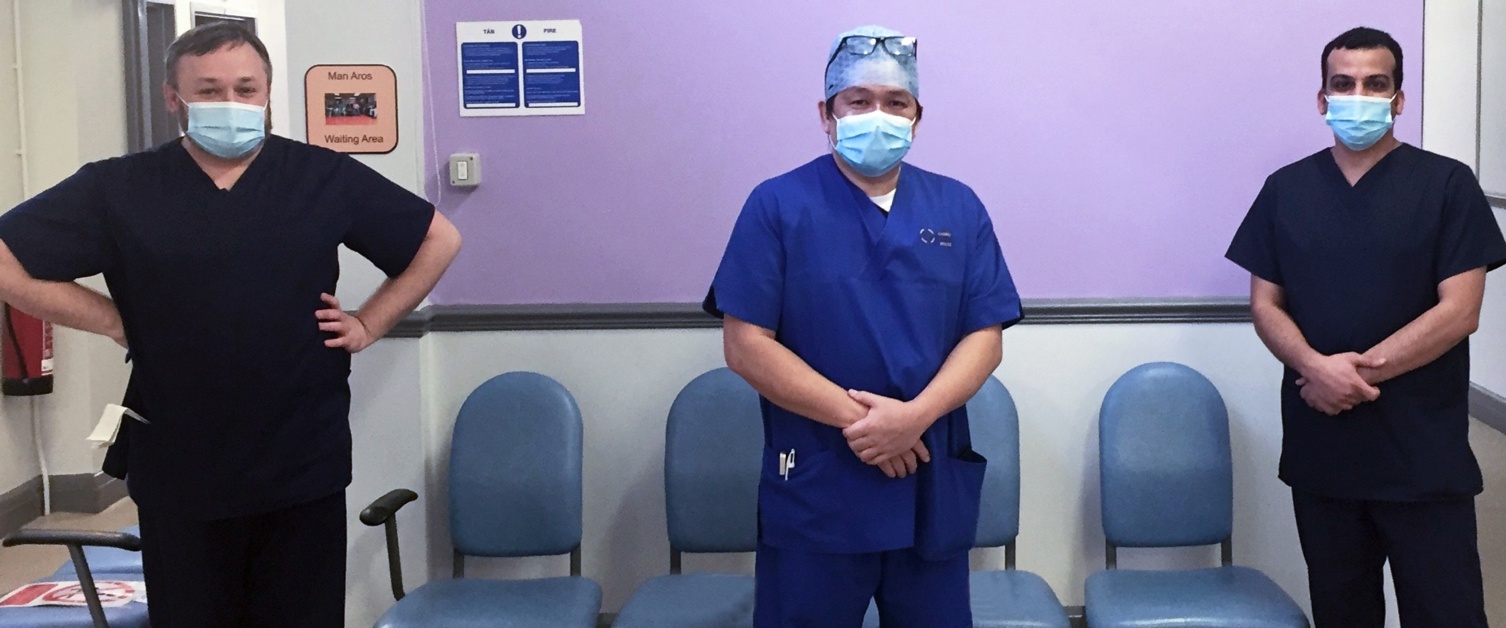 Three clinical staff in hospital waiting area