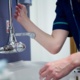 A staff member washing their hands