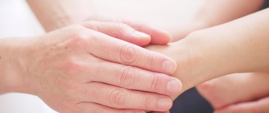 Image of two people holding hands