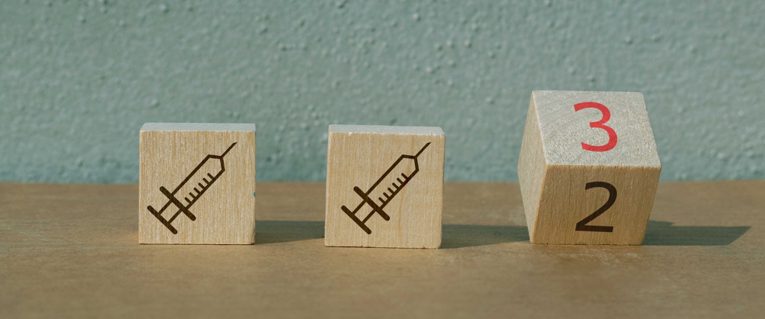 Three wooden blocks - two showing a syringe and one a number 3.