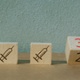 Three wooden blocks - two showing a syringe and one a number 3.