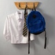 Image shows school shirt, school tie and bag hanging on hooks.