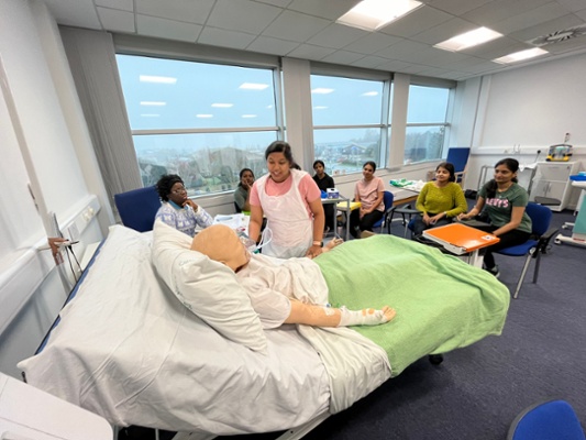 Image shows nurses training with a mannequin