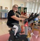 Image shows a woman on a static bicycle
