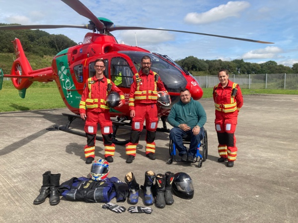 EMRTS crew and charity donor in front of helicopter 