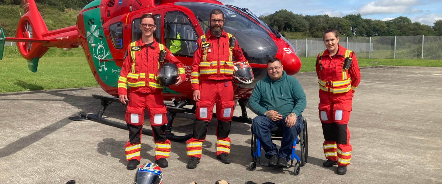 EMRTS crew and charity donor in front of helicopter 