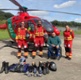 EMRTS crew and charity donor in front of helicopter 