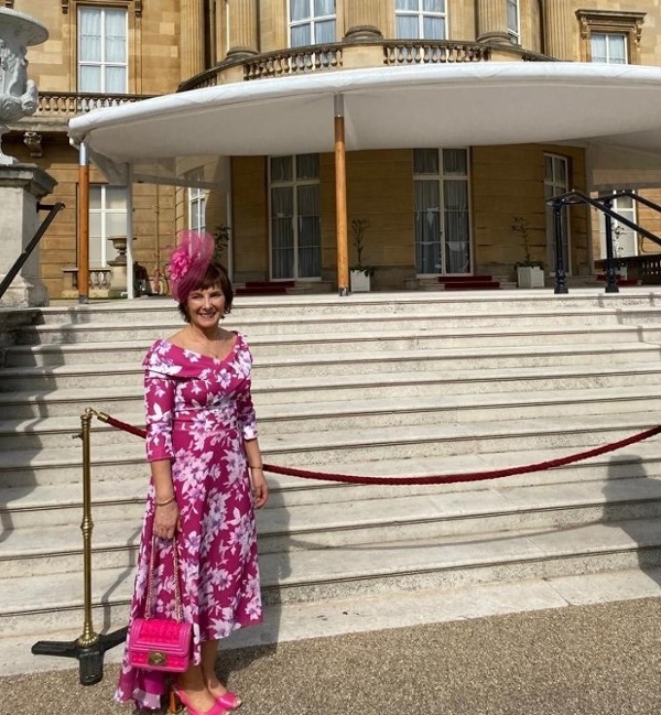 Karen stood outside Buckingham Palace