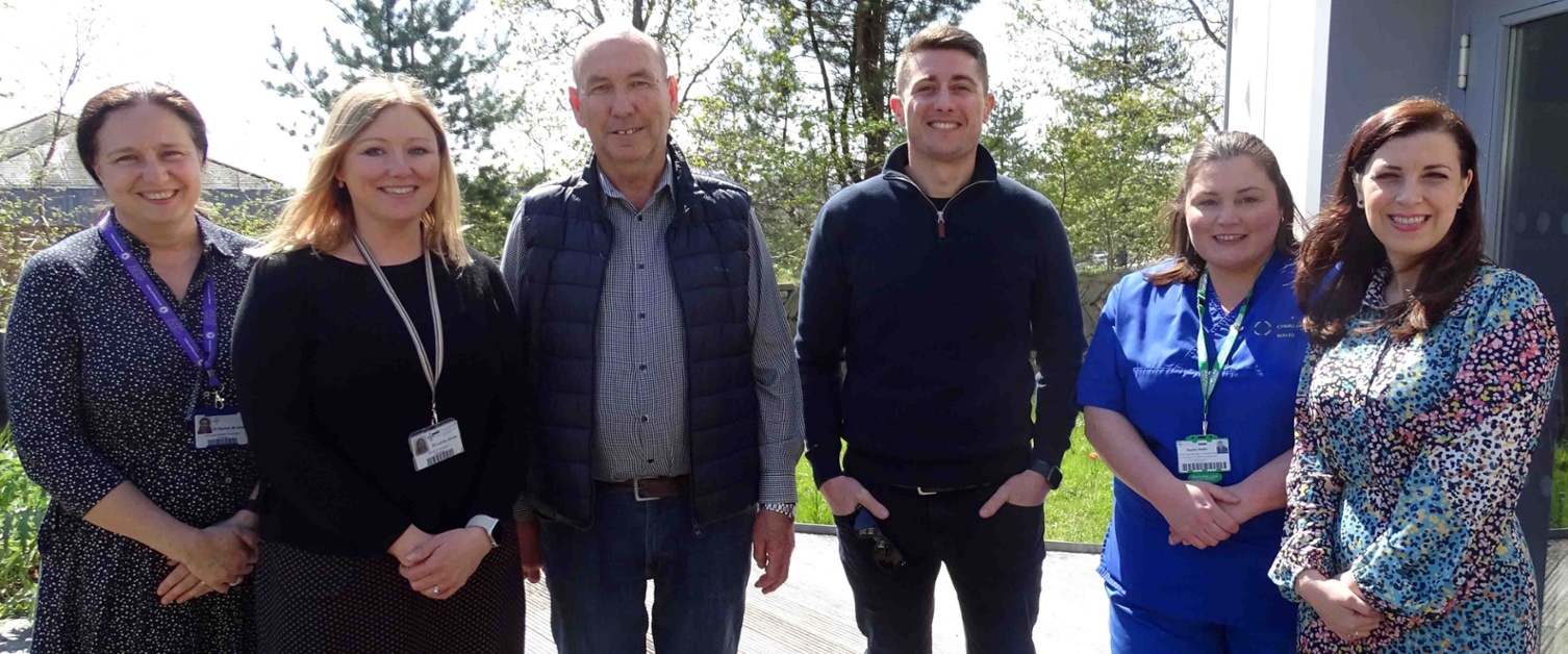 A group of hospital staff and two patients photographed outdoors