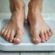 a person weighing themselves