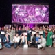 Image shows a group of people during an awards presentation