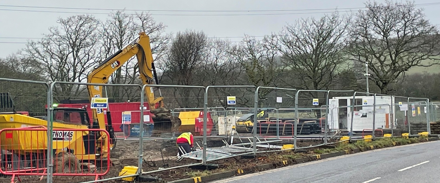 Image shows development work in a field, with trees in the background