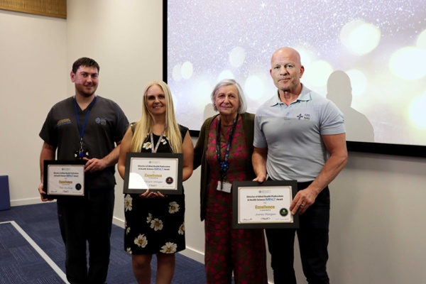 Group image with reward recipients holding their certificates.
