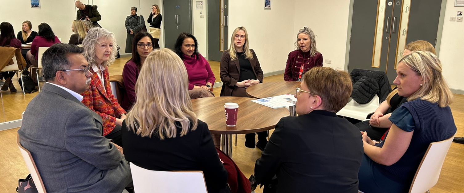Health board staff sat around a table with the Minister