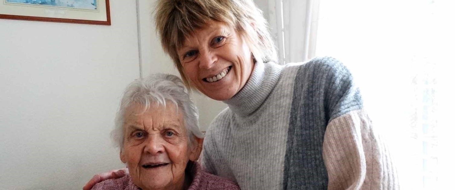 A woman Julie sat next to her mum Patricia North