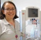 Image shows a neonatal nurse standing next to clinical equipment.