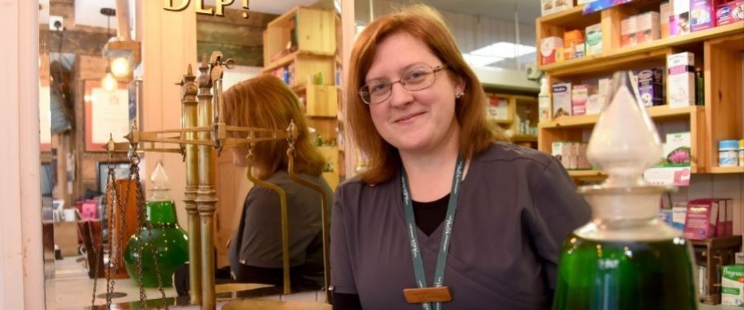 Pharmacist Elizabeth Lawless stood behind the counter at The Health Dispensary smiling at the camera.