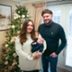 Image shows a couple holding their baby.