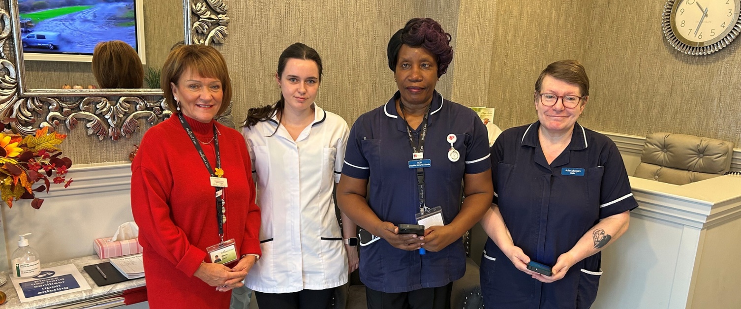 Staff stood together inside the care home