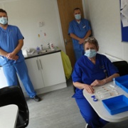 Staff prepare Covid booster vaccinations inside the converted shipping container.