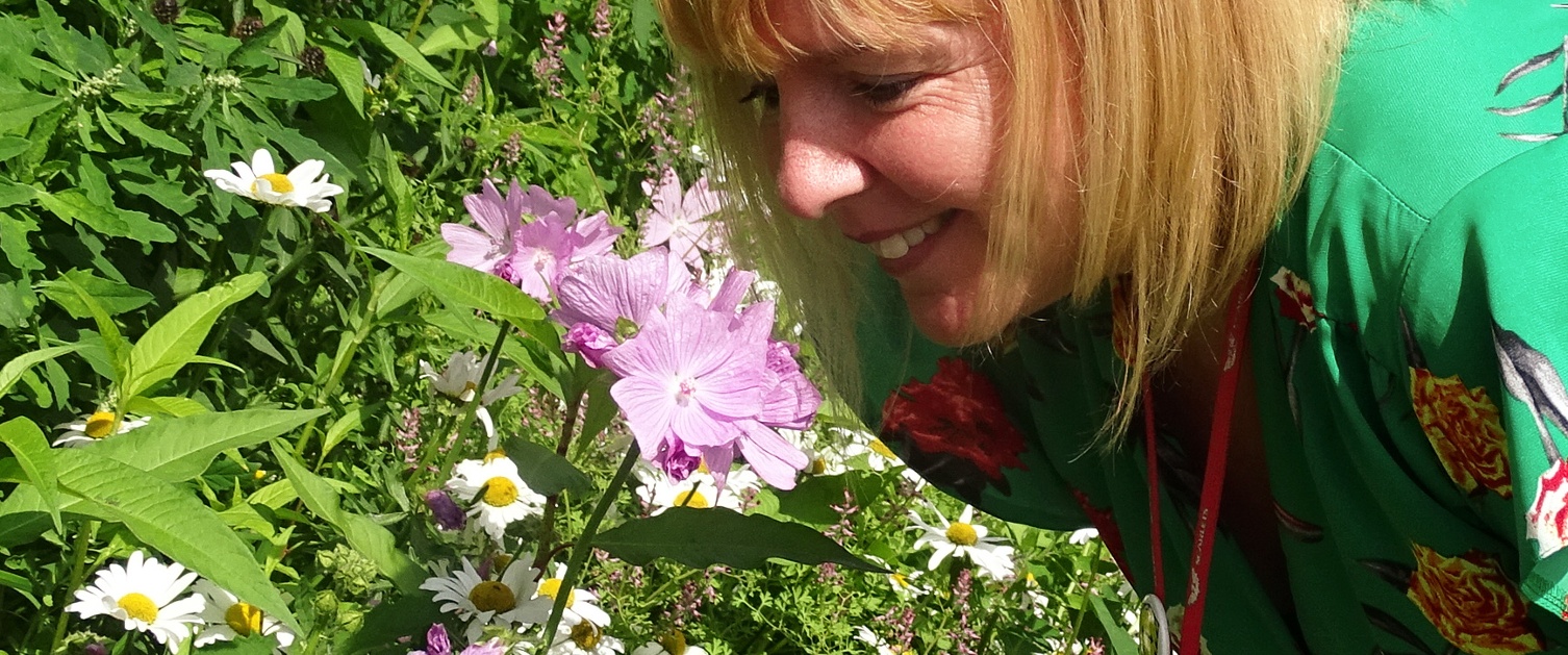 Woman enjoying scent of wild flowers