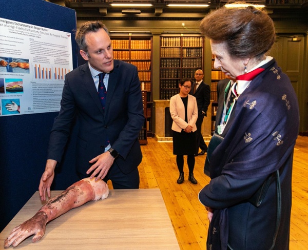 Jonathan Cubitt explains the artificial arm to the Princess Royal