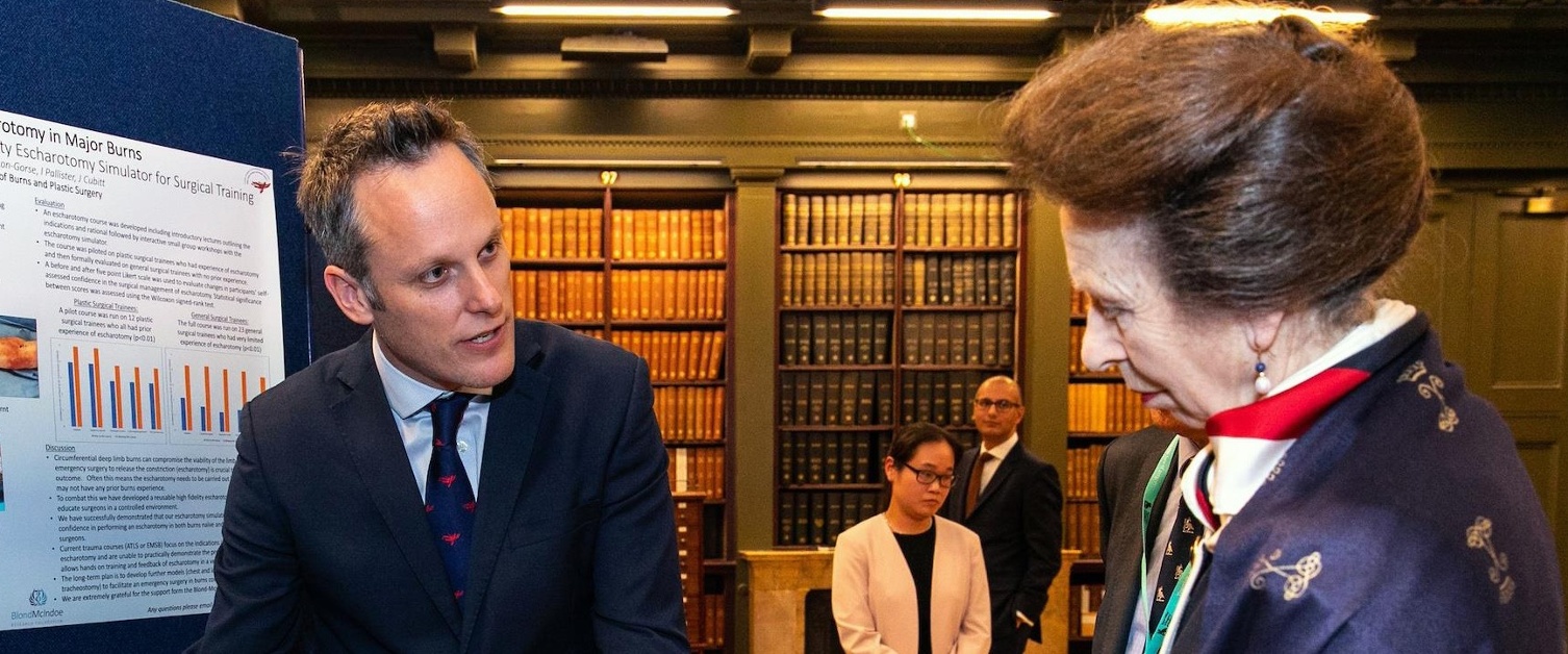 Jonathan Cubitt explains the artificial arm to the Princess Royal