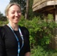 Image shows a woman smiling at the camera.