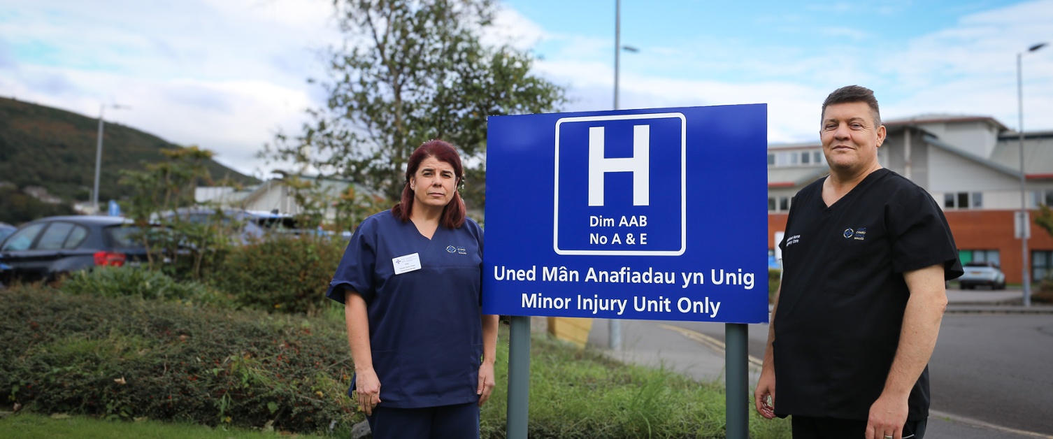 Staff stood next to the Minor Injury Unit sign