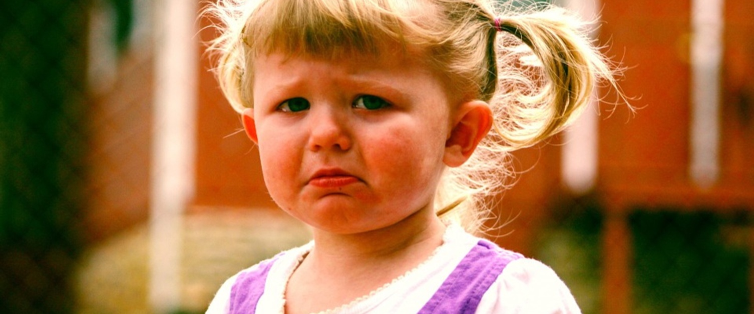 A young girl who is very unhappy and having a tantrum