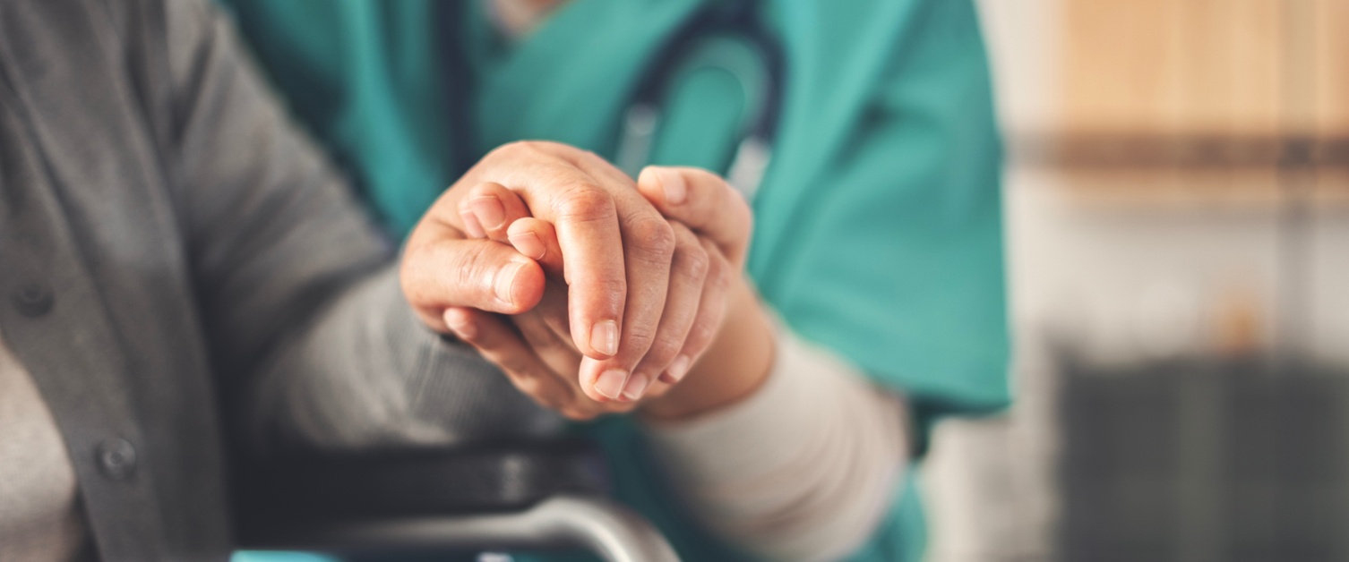 Image shows nurse comforting patient.