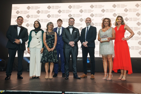 Image shows a group of people standing on a stage