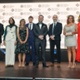 Image shows a group of people standing on a stage