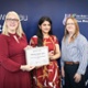 Sowndarya and Anna being presented with a certificate