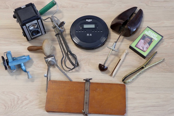 A number of vintage items are laid out on a table.