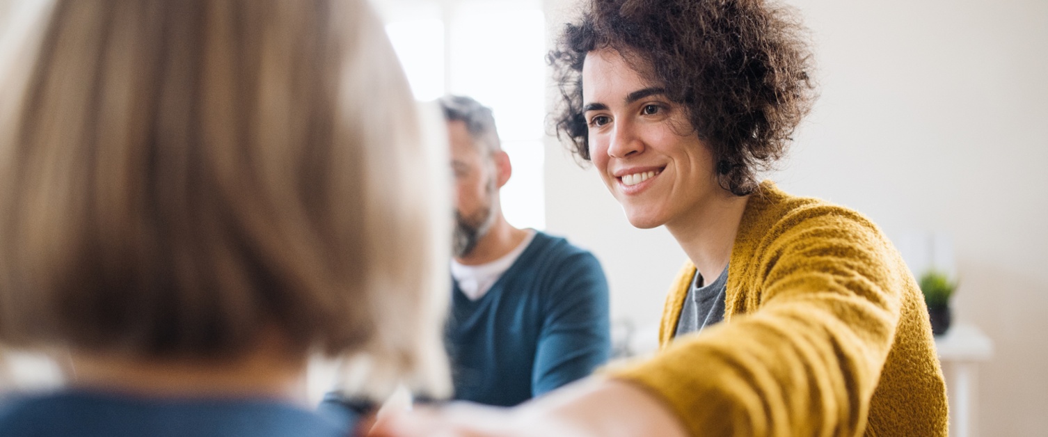 Image shows a person holding someone’s shoulder for support.