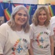 Three members of staff in Happy Pride t shirts are smiling.