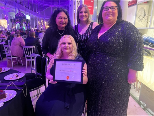 Image shows a group of women with an award