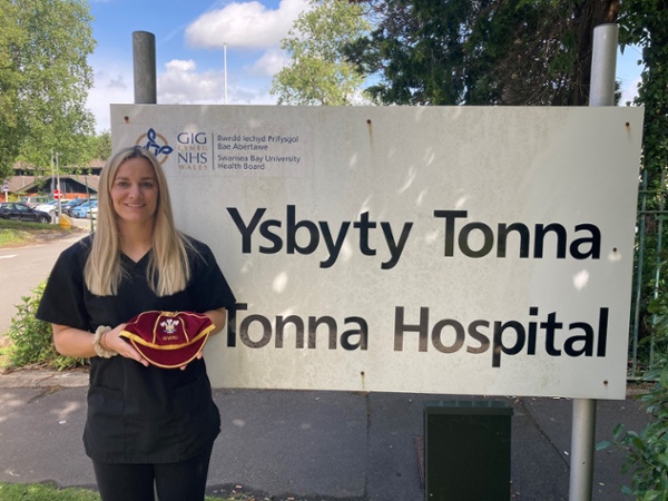 Kerin holding her Welsh cap outside the hospital