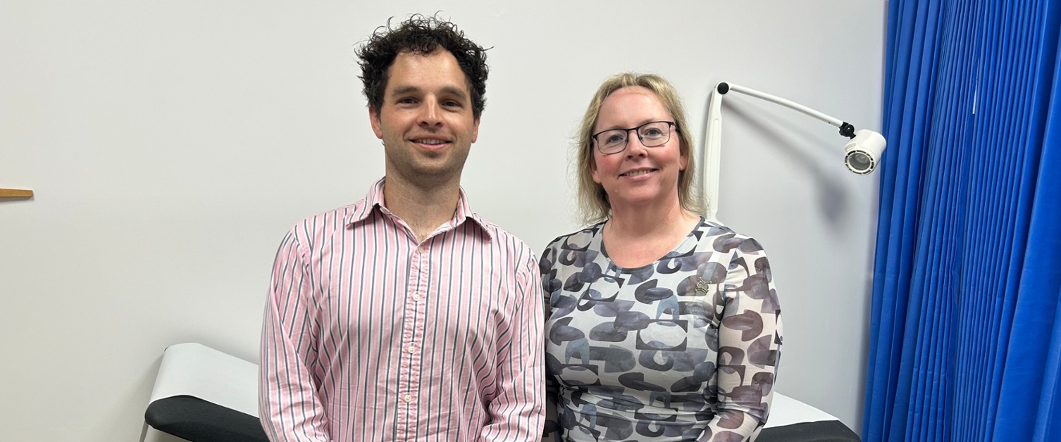 Dan and Charlotte stood in a GP consulting room