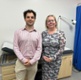 Dan and Charlotte stood in a GP consulting room