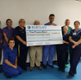 Dan Danino ward staff holding a cheque